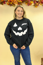 Load image into Gallery viewer, Model is wearing a Jack o lantern inspired sweatshirt
