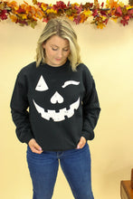 Load image into Gallery viewer, Model is wearing a Jack o lantern inspired sweatshirt
