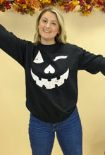 Load image into Gallery viewer, Model is wearing a Jack o lantern inspired sweatshirt
