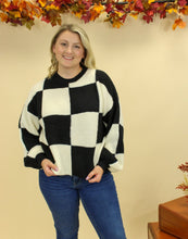 Load image into Gallery viewer, Model is wearing a black and white checkered sweater. 
