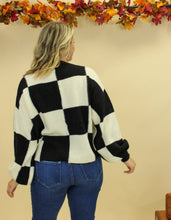 Load image into Gallery viewer, Model is wearing a black and white checkered sweater. 
