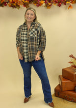 Load image into Gallery viewer, Model is wearing a plaid oversized button up shirt. 
