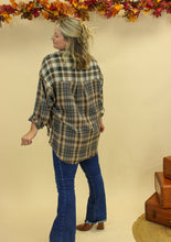 Load image into Gallery viewer, Model is wearing a plaid oversized button up shirt. 
