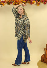 Load image into Gallery viewer, Model is wearing a plaid oversized button up shirt. 
