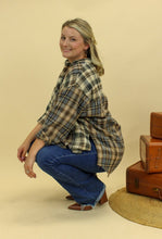 Load image into Gallery viewer, Model is wearing a plaid oversized button up shirt. 
