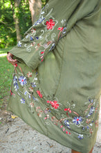 Load image into Gallery viewer, Model is wearing a green kimono with red and blue embroidered florals.
