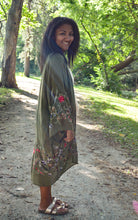 Load image into Gallery viewer, Model is wearing a green kimono with red and blue embroidered florals.
