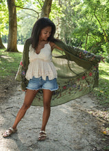 Load image into Gallery viewer, Model is wearing a green kimono with red and blue embroidered florals.

