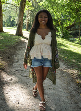 Load image into Gallery viewer, Model is wearing a green kimono with red and blue embroidered florals.
